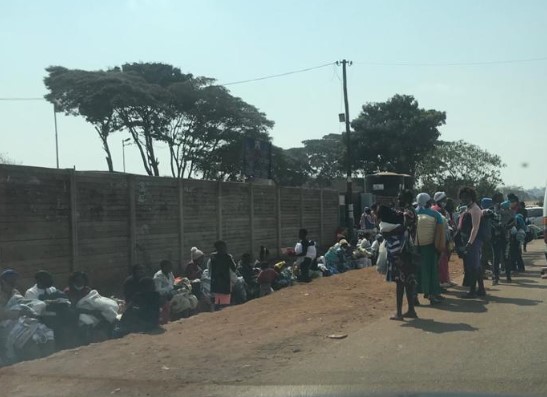Mothers queuing outside a polyclinic as part of decongesting the health facilities during the COVID-19 lockdown period