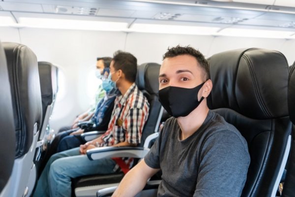 Person wearing a well-fitting mask on a flight