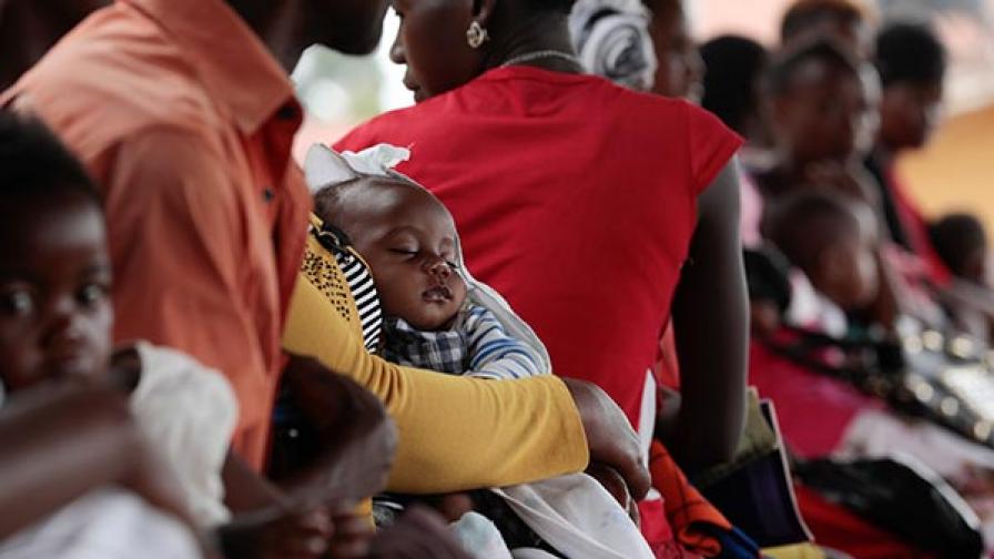 Image shows a child in the waiting area of Kasangati Health Centre, in Wakiso District, Uganda.