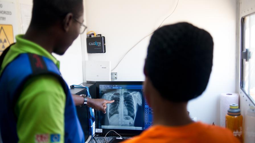 Healthcare workers reviewing chest x-ray